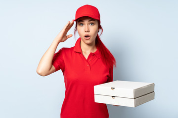 Pizza delivery girl holding a pizza over isolated background has realized something and intending the solution