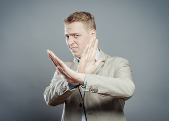 man hands crossing fingers forming an x
