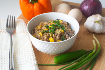 Chinese style vegetarian egg fried rice with sweet corn, green peas, onions, garlic, mushrooms and scallions