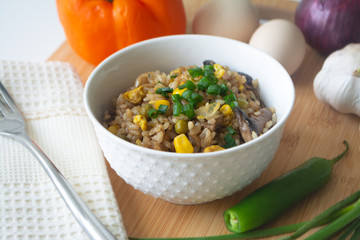 Chinese style vegetarian egg fried rice with sweet corn, green peas, onions, garlic, mushrooms and scallions