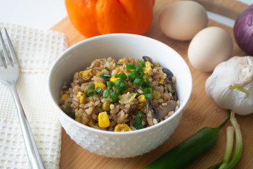 Chinese style vegetarian egg fried rice with sweet corn, green peas, onions, garlic, mushrooms and scallions