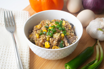 Chinese style vegetarian egg fried rice with sweet corn, green peas, onions, garlic, mushrooms and scallions