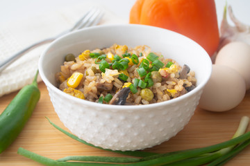 Chinese style vegetarian egg fried rice with sweet corn, green peas, onions, garlic, mushrooms and scallions