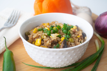 Chinese style vegetarian egg fried rice with sweet corn, green peas, onions, garlic, mushrooms and scallions