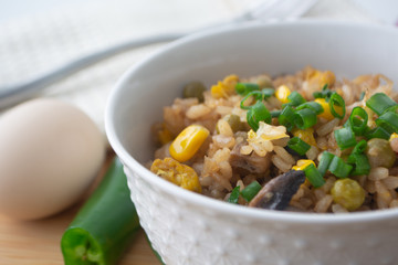 Chinese style vegetarian egg fried rice with sweet corn, green peas, onions, garlic, mushrooms and scallions