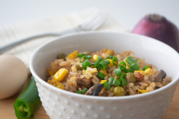 Chinese style vegetarian egg fried rice with sweet corn, green peas, onions, garlic, mushrooms and scallions