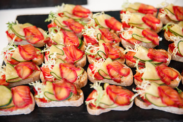 on a wooden table in the wedding banquet area are snacks, fruits, sweet cakes and muffins and lemonade drink