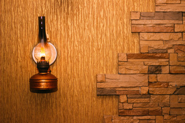 Kerosene lamp on the wall. Vintage style. Fire. Atmospheric photo. Light.