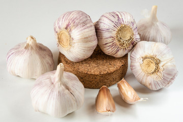Garlic bulbs and garlic cloves on a white background.