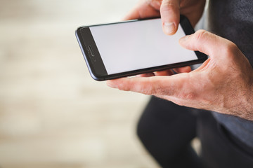 Man using smartphone with white screen for text. Surfing on internet or online shopping concept.