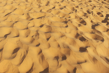 yellow sand of the desert. Sand texture. Sandy beach for background. View from above