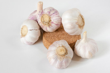 Garlic bulbs and garlic cloves on a white background.