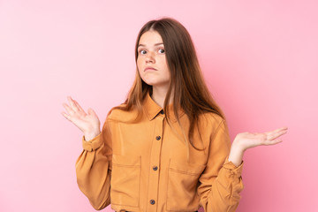 Ukrainian teenager girl over isolated pink background making doubts gesture
