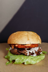 juicy burger with chicken and lamb meat on a dark background