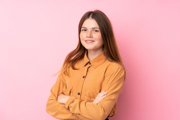 Obraz premium Ukrainian teenager girl over isolated pink background with arms crossed and looking forward
