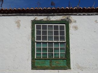 Fototapeta premium Traditional guillotine wood window in historic colonial house. Old city center of Santa Cruz. La Palma Island. Canary Islands. Spain. 