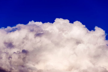 Large multi-colored clouds on a blue sky. Dark storm clouds. overcast sky