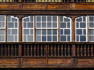 Fototapeta na wymiar Detail of historic traditional house with glazed enclosed balcony in the old city center of Santa Cruz. La Palma Island. Canary Islands. Spain. 