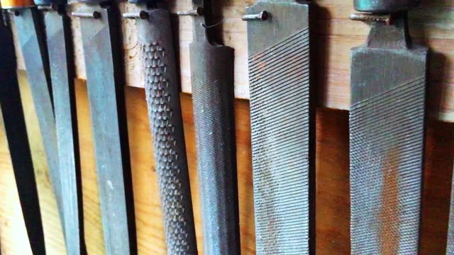 Tools files in workshop to work with wood close up on the wall. Rasp instrument many