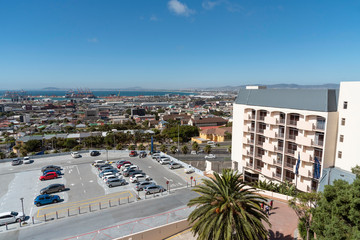 Cape Town, South Africa. 2019. Hotel and car park with a view across housing and Cape Town port