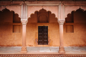 Fototapeta premium Beautiful entrance with red door and arch in India 