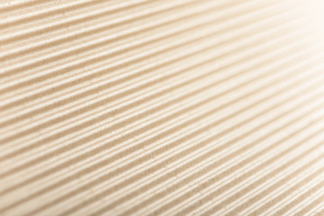 Carton or cardboard packing material. Texture of corrugated paper sheets made from cellulose. Supplies for creating boxes and packaging. Pasteboard background. Natural brown cardboard surface.