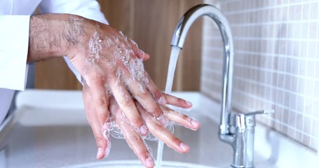 Man washing hands properly with soap to be protected for Coronavirus 2019-nCoV pandemic epidemic infection. Doctor shows how to wash hands properly. - Powered by Adobe