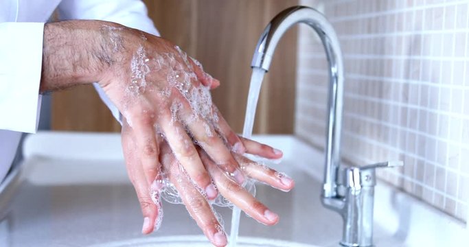 Man washing hands properly with soap to be protected for Coronavirus 2019-nCoV pandemic epidemic infection. Doctor shows how to wash hands properly. - Powered by Adobe