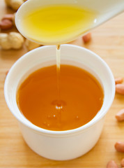 Peanut vegetable oil in a bowl close up
