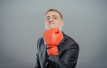 businessman in boxing gloves cause to fight, shows that hit isolated