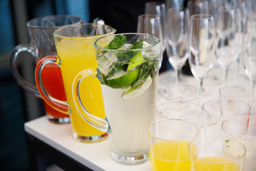 on a wooden table in the wedding banquet area are snacks, fruits, sweet cakes and muffins and lemonade drink