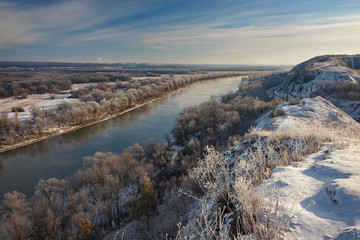 The first snow on the river, grass and trees. Autumn landscape in central Russia.