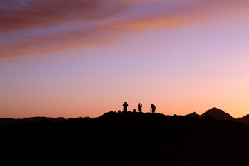 Turists taking pictures at sunset