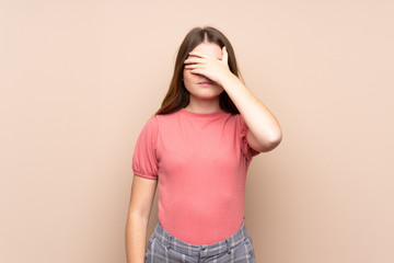 Ukrainian teenager girl over isolated background covering eyes by hands