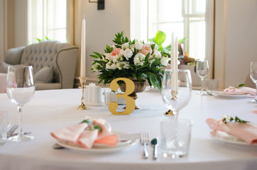Table for wedding with white ang light pink flowers  in restaraunt 