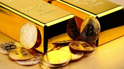 Bitcoins of new digital money and gold bars on golden background