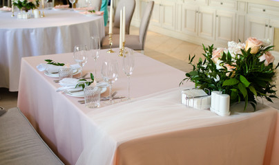 Table for wedding with white ang light pink flowers  in restaraunt 