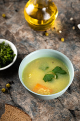 Chicken broth soup with carrot and herbs