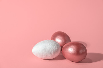 Easter decorative white and golden eggs on colorful background. Holidays card, copy space