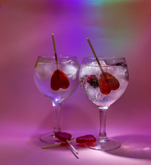 Romantic gin and tonic cocktail with candy hearts