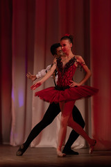 Duet young girl ballerina and a young man dancing ballet performance on stage in a theater © Kozlik_mozlik