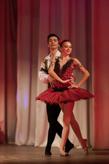 Duet young girl ballerina and a young man dancing ballet performance on stage in a theater © Kozlik_mozlik