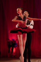 Duet young girl ballerina and a young man dancing ballet performance on stage in a theater © Kozlik_mozlik