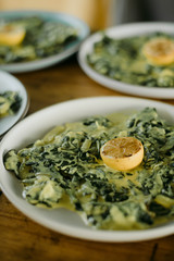 Lemon on Creamy Greens Served for Dinner 