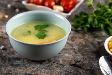 Potato soup with herbs in a blue bowl