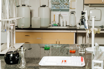 Samples in lab glassware surrounded by lab equipment in hospital laboratory ready for testing and research for covid 19 or coronavirus vaccination