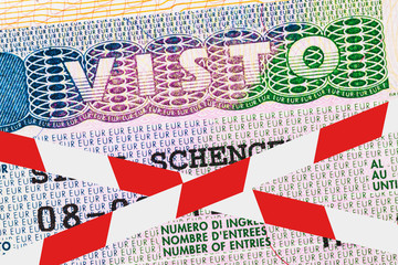 The visa stamp in the passport is crossed out with a barrier tape. Concept on the prohibition of entry into the Schengen area due to the covid-19 pandemic. Travel restrictions for tourists