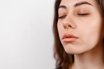 Fototapeta premium Close-up portrait of a cute brunette European smiling woman. makeup and beauty