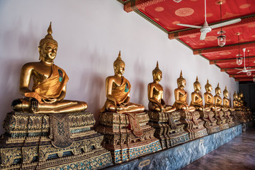 Buddha statues in the gallery of a Thai temple