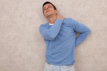 Man with neck and lower back pain, Sport injury. Pain Relief and Health Care Concept.